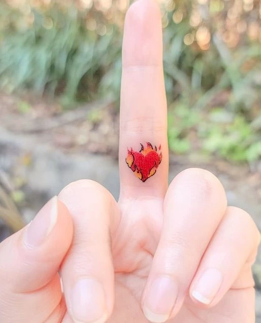burning heart on the middle finger