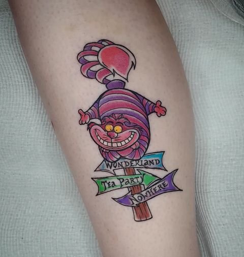 funny cheshire cat tattoo on the hand