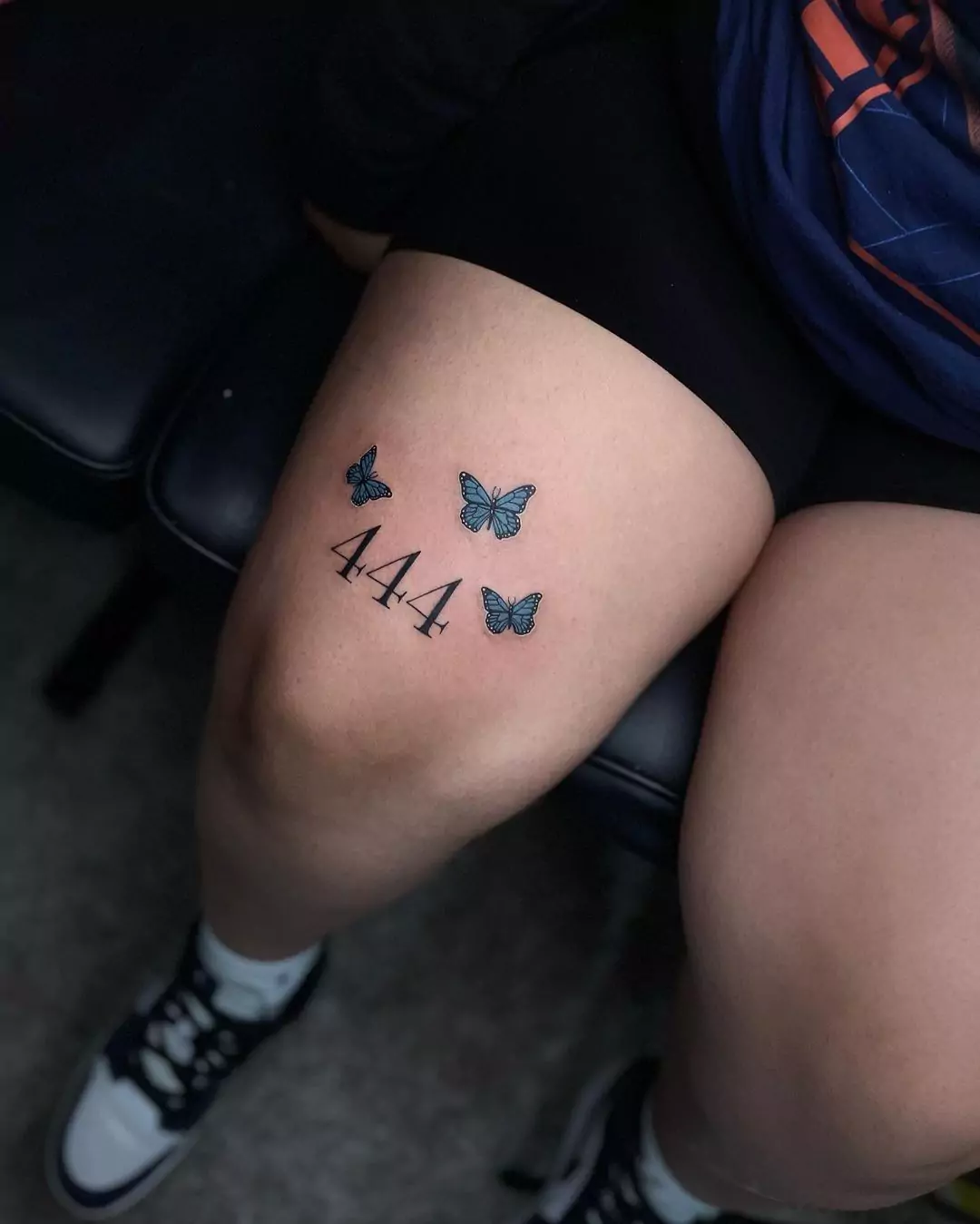 444 with butterfly leg tattoo