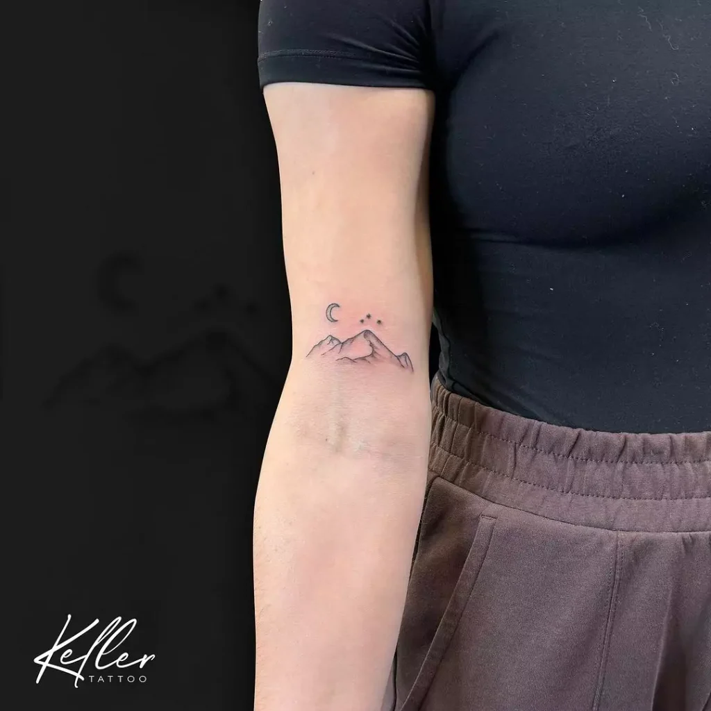 Fine line style mountain tattoo