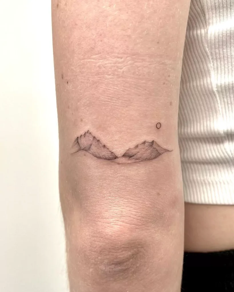 Minimalistic mountain tattoo