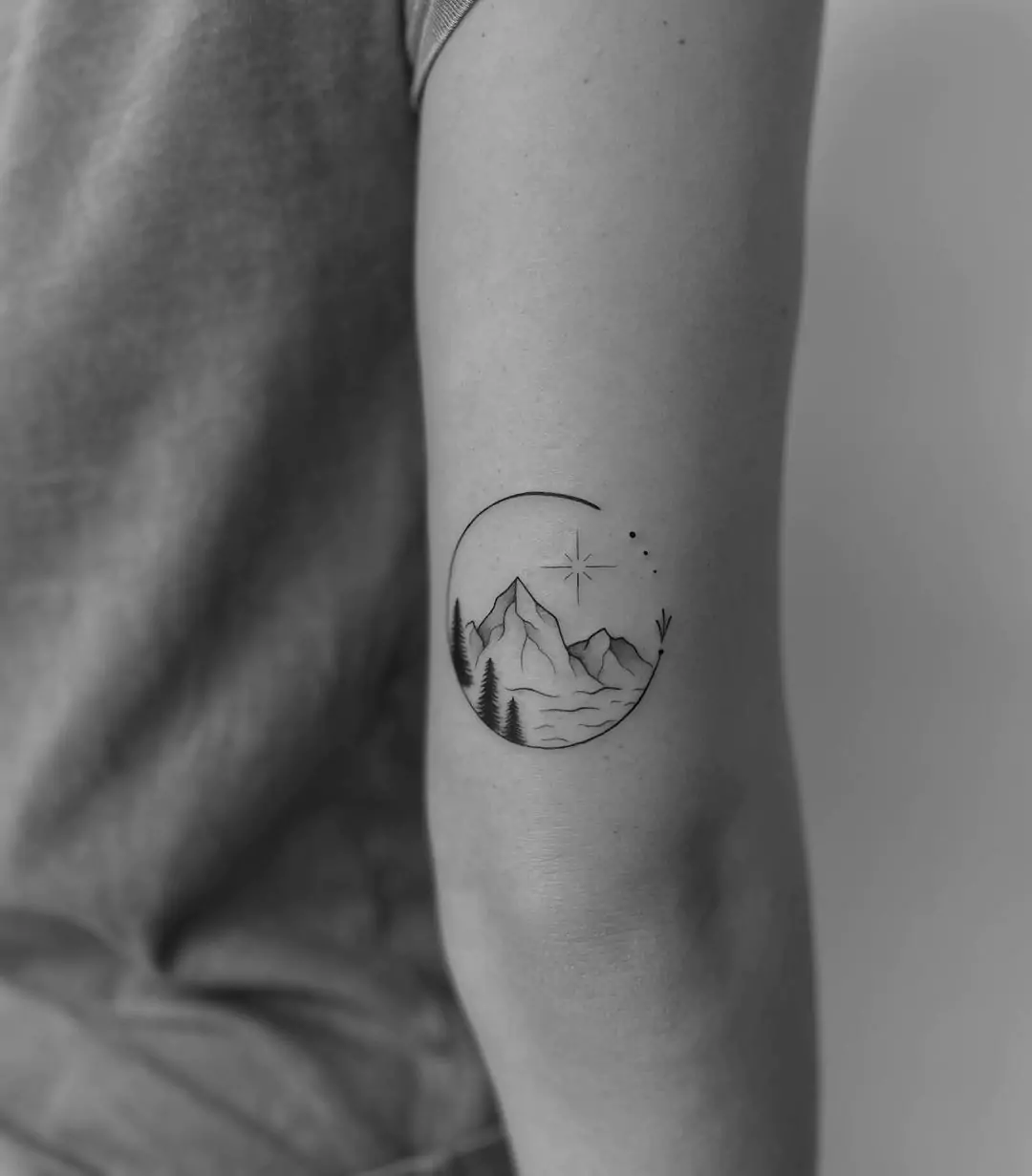 black and gray simple mountain tattoo inside half circle
