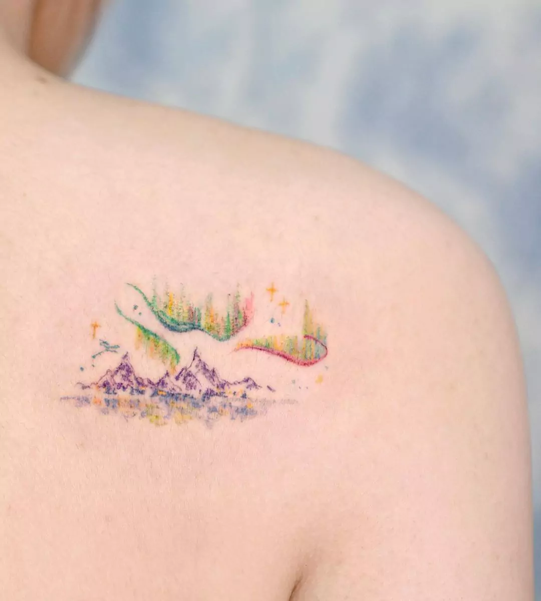 colorful brush style mountain back tattoo