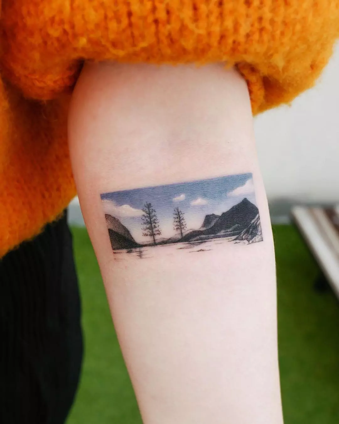colorful landscape mountain hand tattoo
