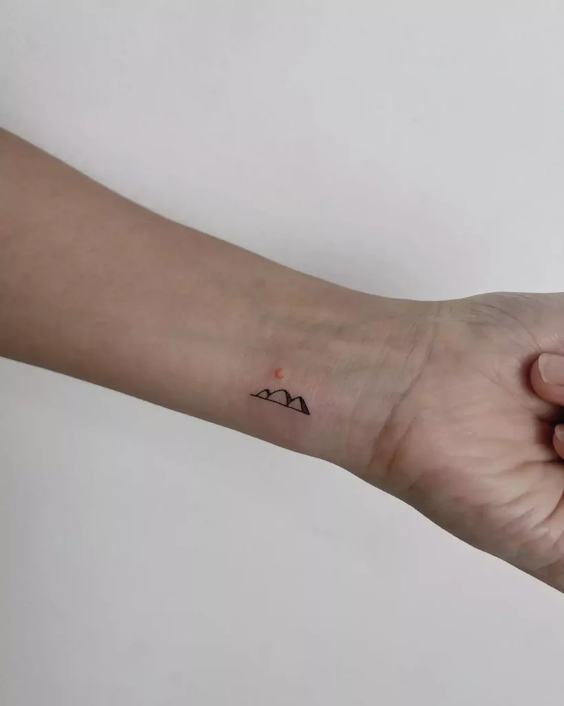 cute and tiny mountain wrist tattoo