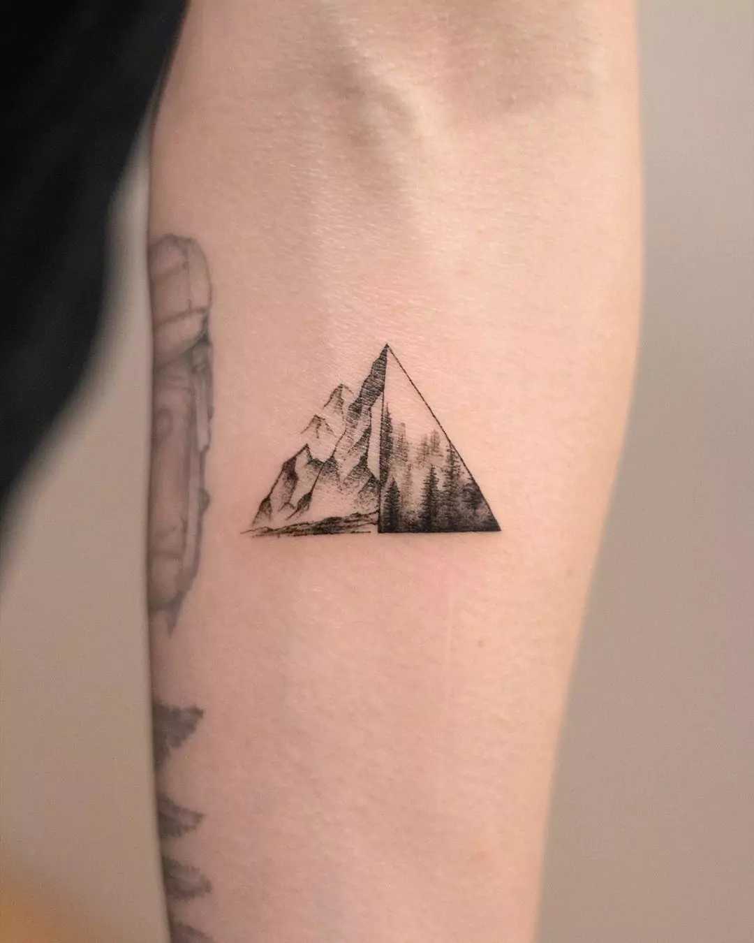 dark black mountain tattoo in triangle