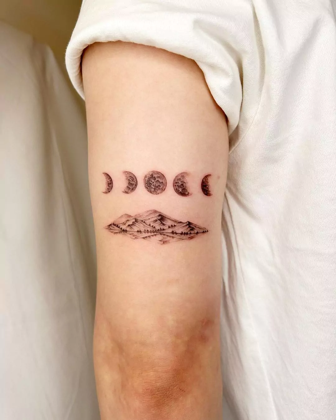 moon phases and mountain hand tattoo