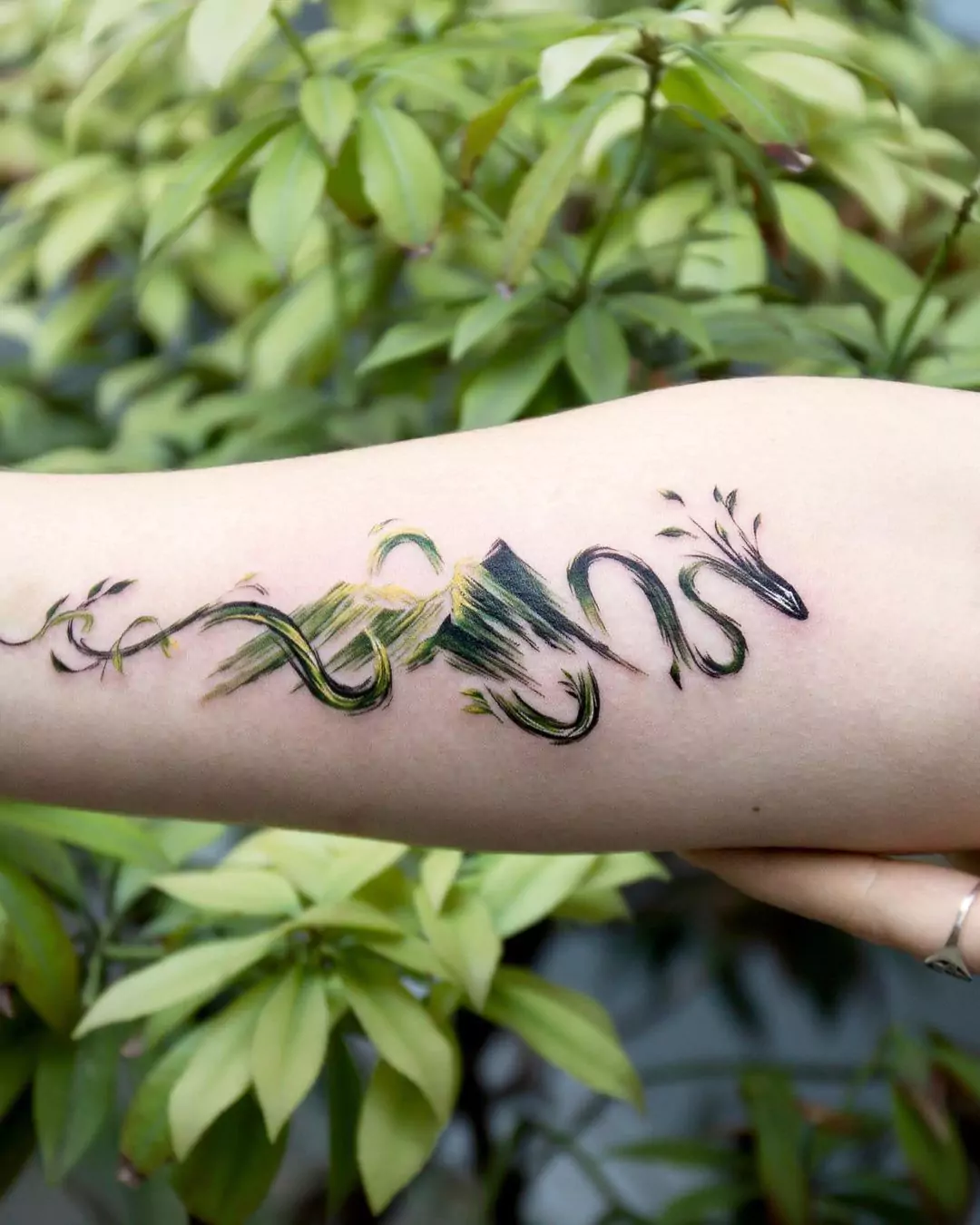 mountain dragon hand tattoo