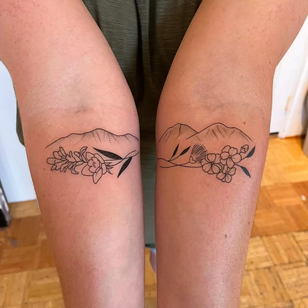 mountain tattoo with floral touch