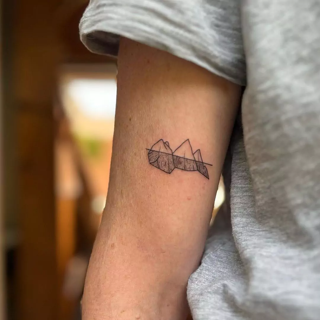 outline mountain tattoo on the hand