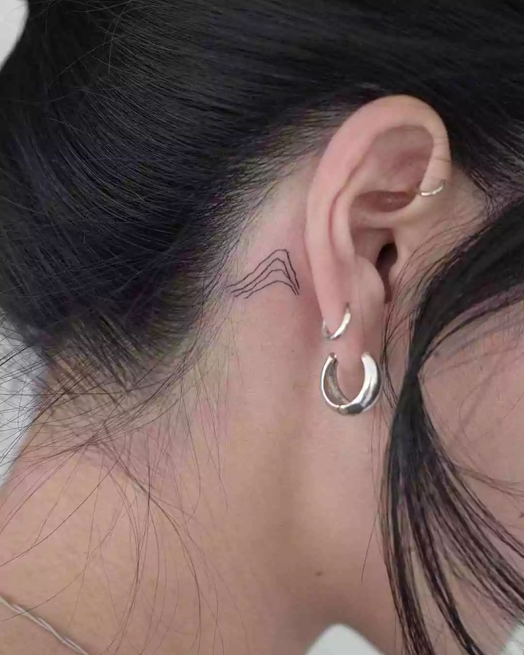 simple line mountain behind the ear tattoo