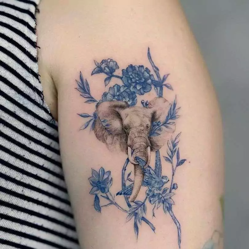 Elephant and floral tattoo on the hand