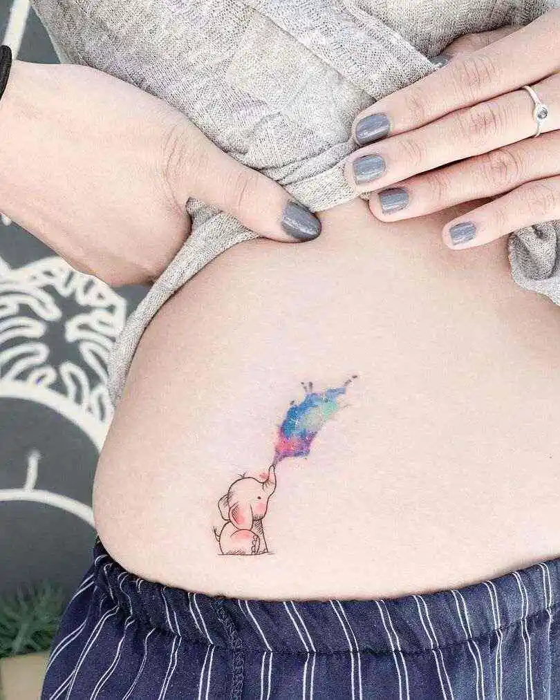 cute and tiny elephant tattoo on the waist