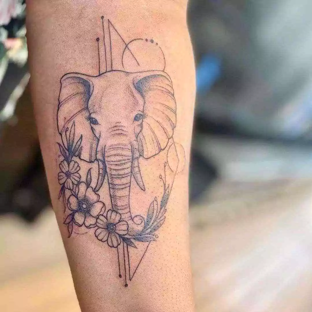 elephant tattoo with floral touch