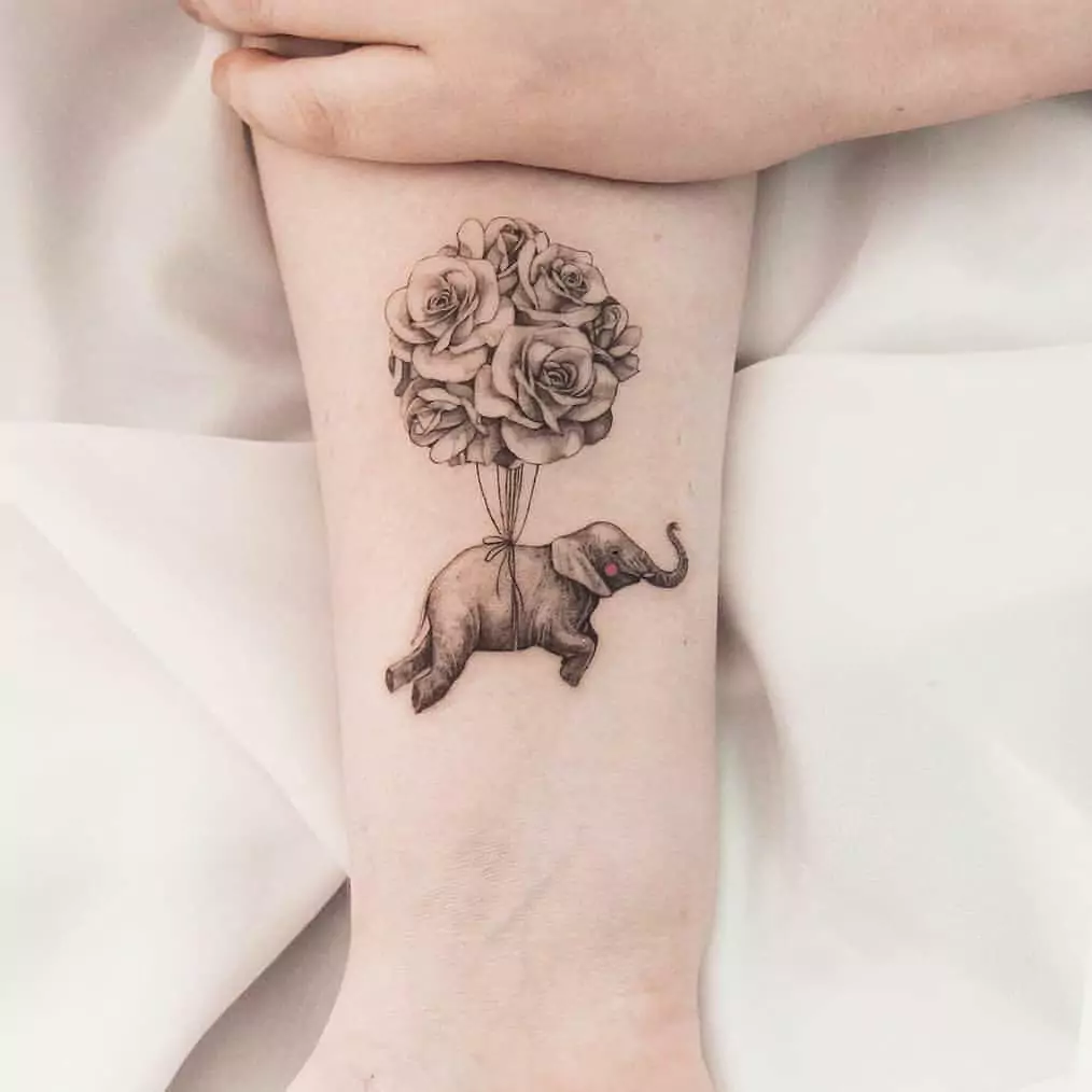 flying elephant tattoo on the hand