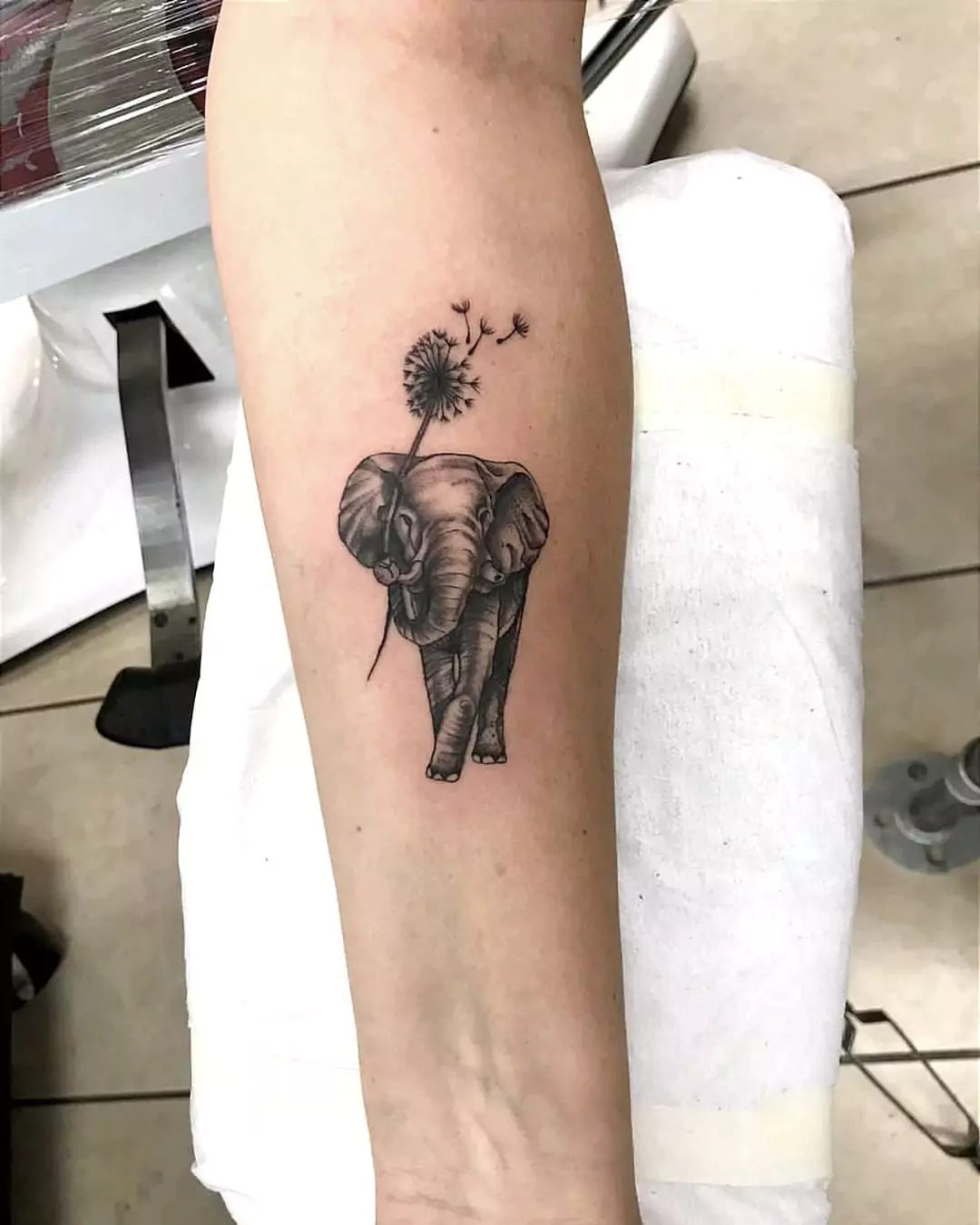 walking elephant tattoo with dandelions