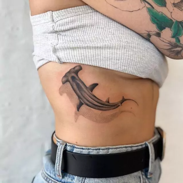 black hammerhead shark tattoo on the rib