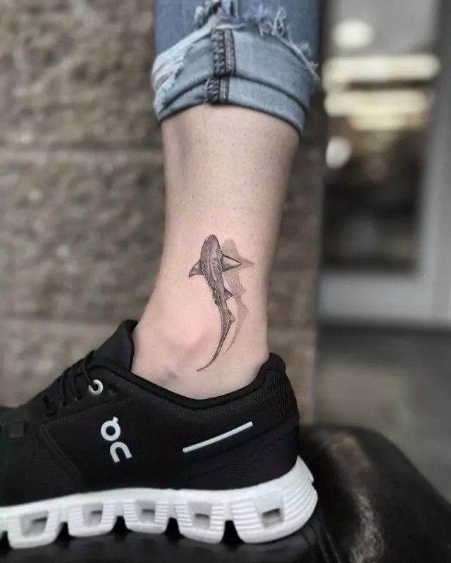 flowing shark leg tattoo