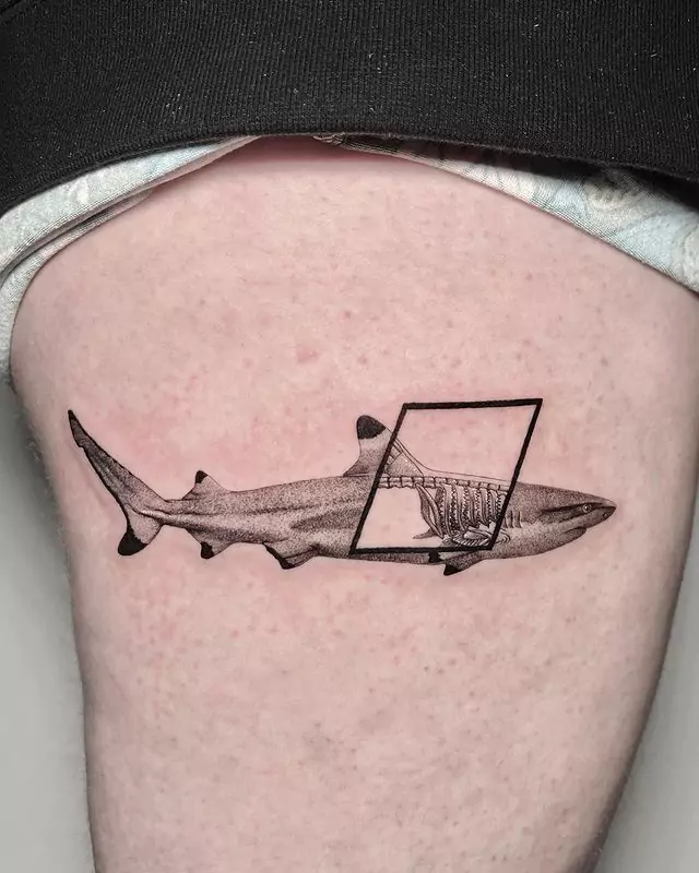 realistic half-skeleton shark tattoo on the thigh