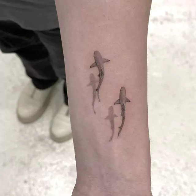 two small shark wrist tattoos