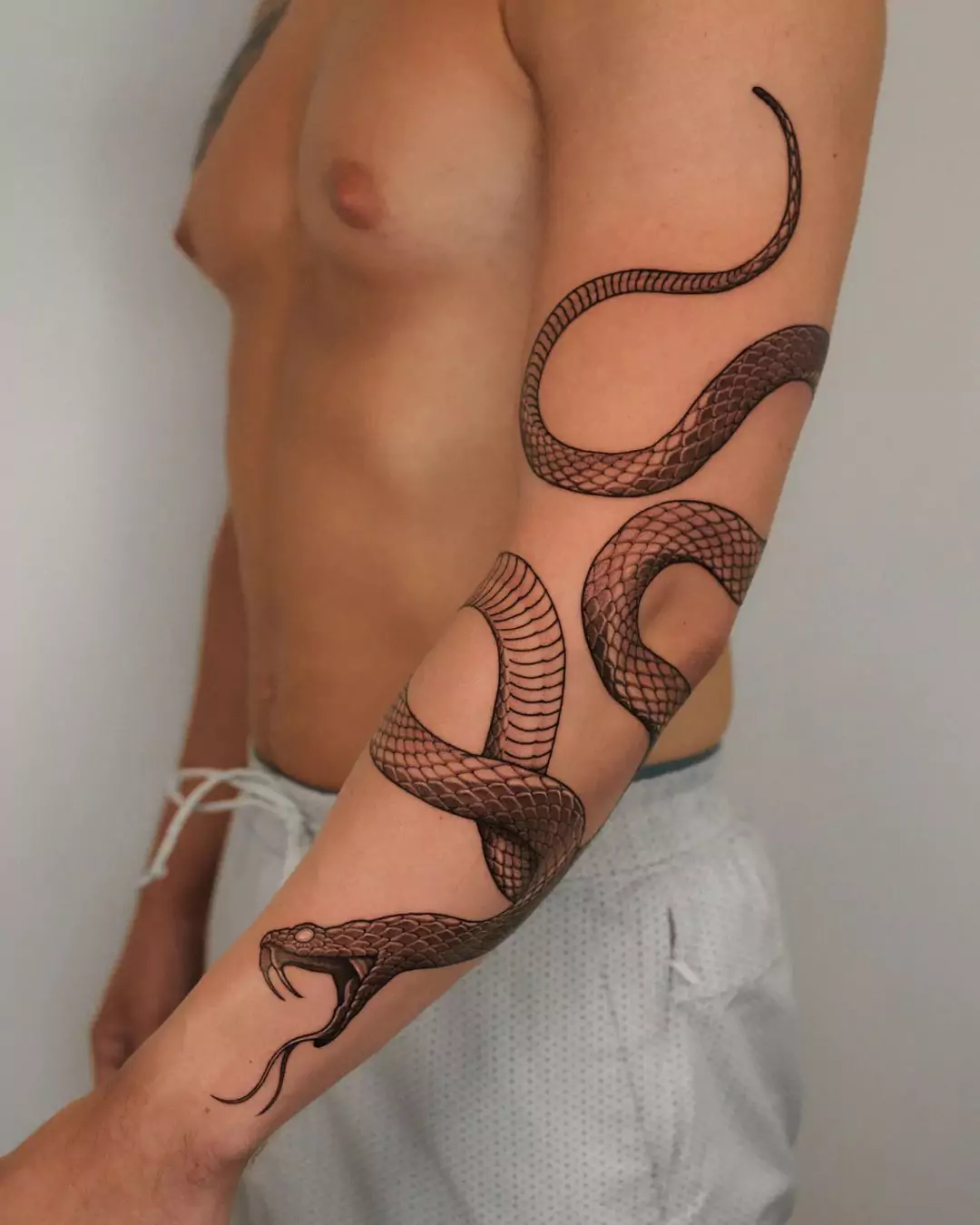 big snake arm tattoo