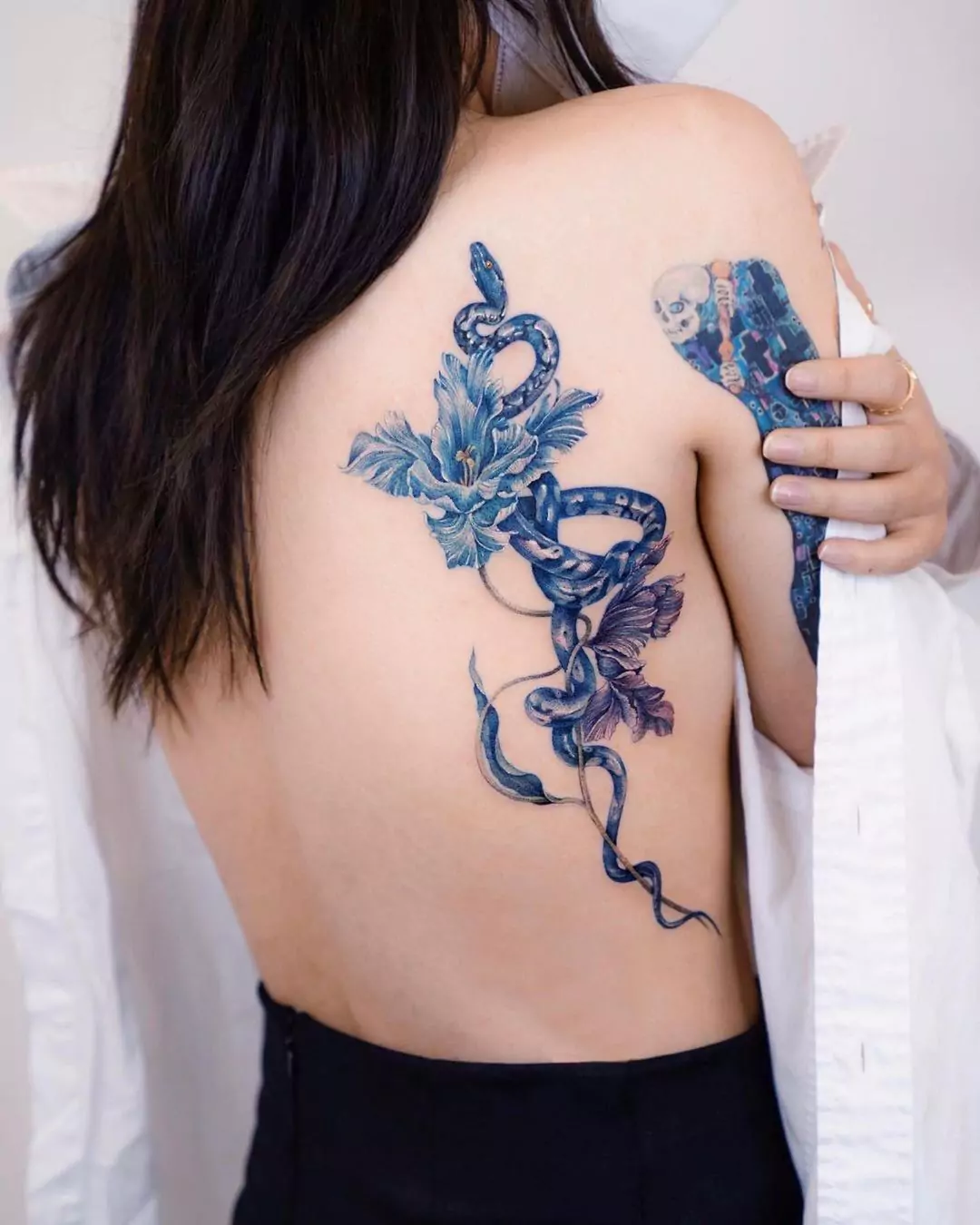 blue snake tattoo on the back