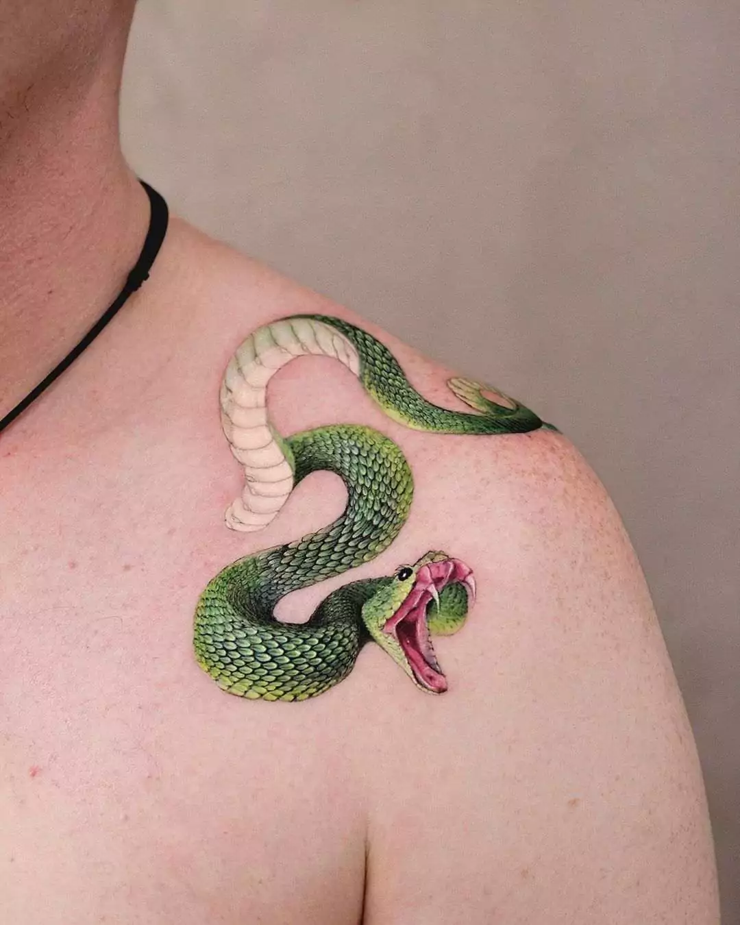 green snake shoulder tattoo