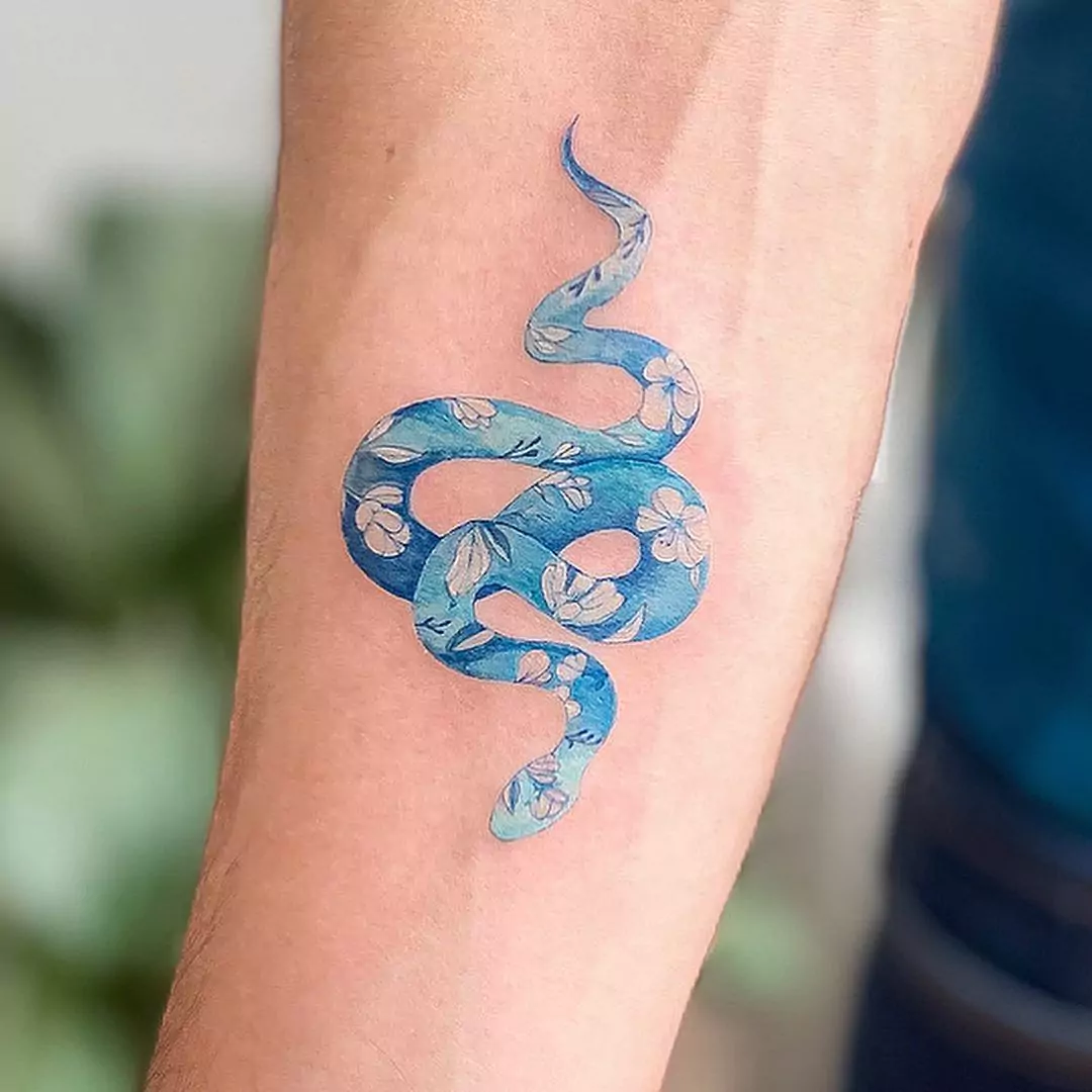 blue snake tattoo with flowers