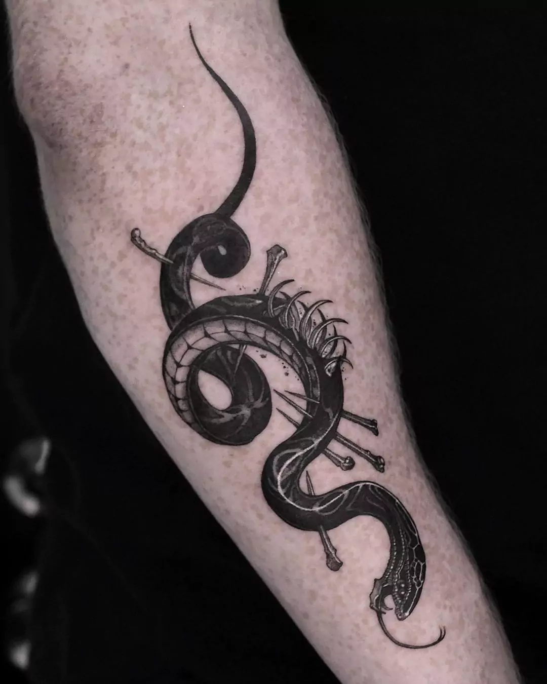 injured snake tattoo