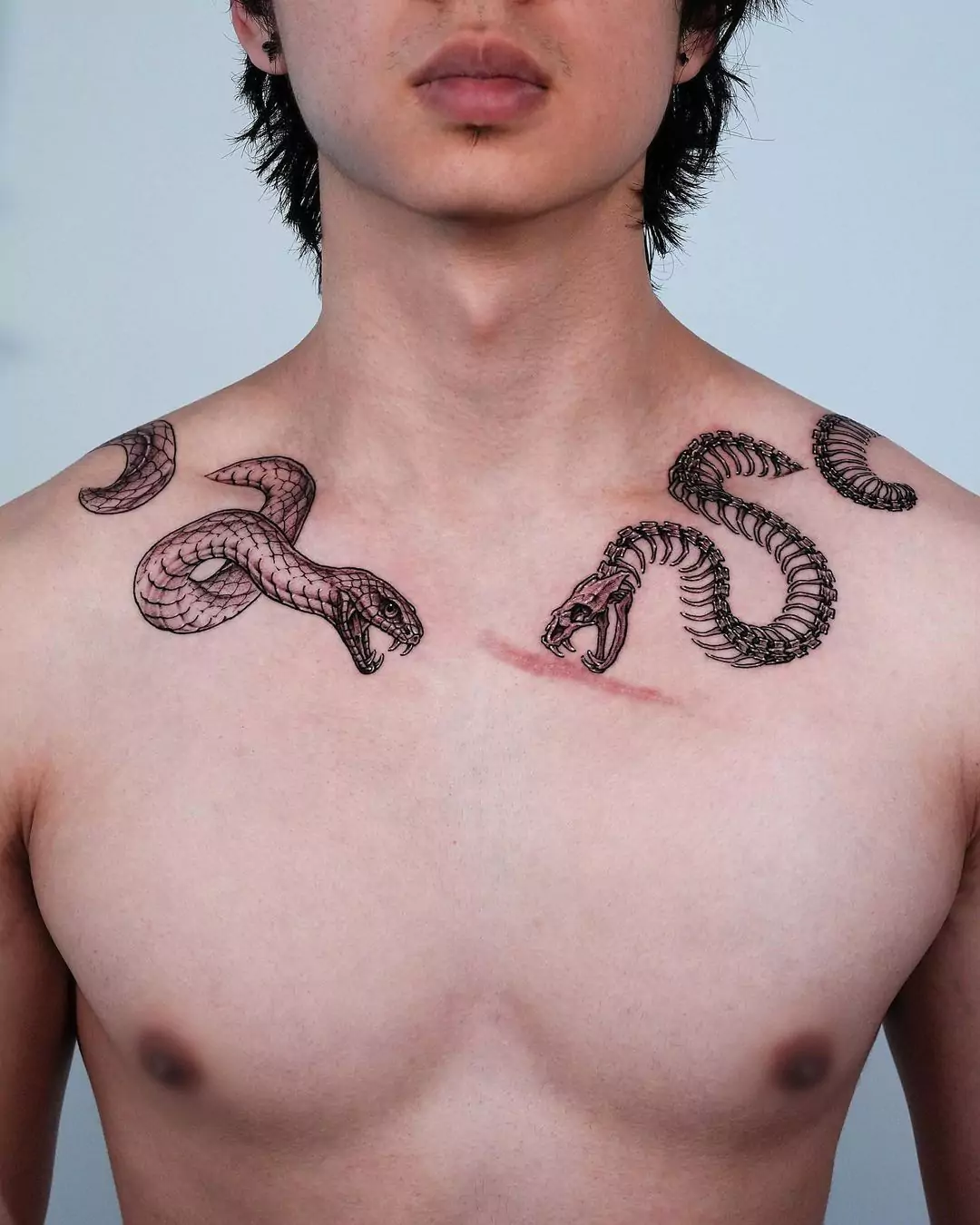 killer snake collarbone tattoos