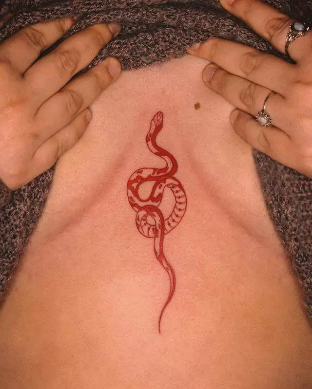 red snake sternum tattoo