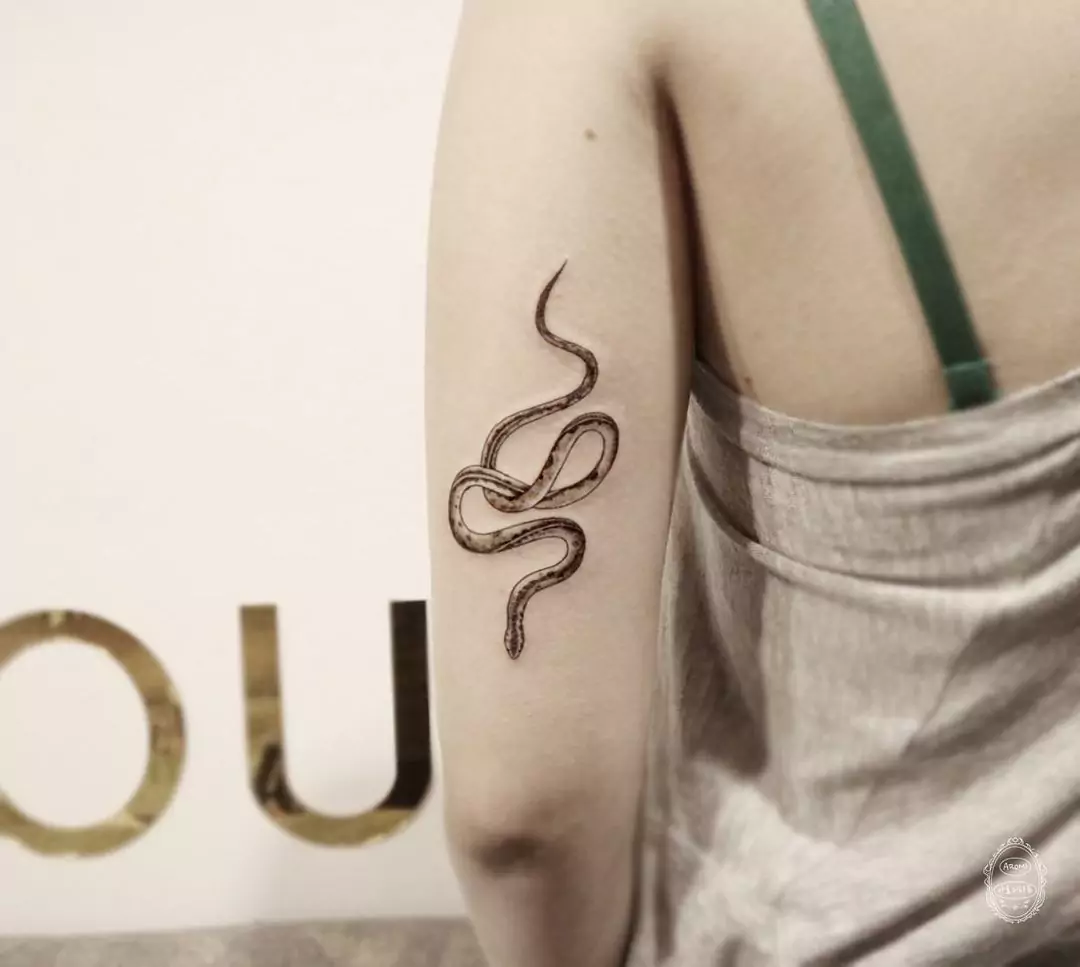 simple and realistic snake arm tattoo