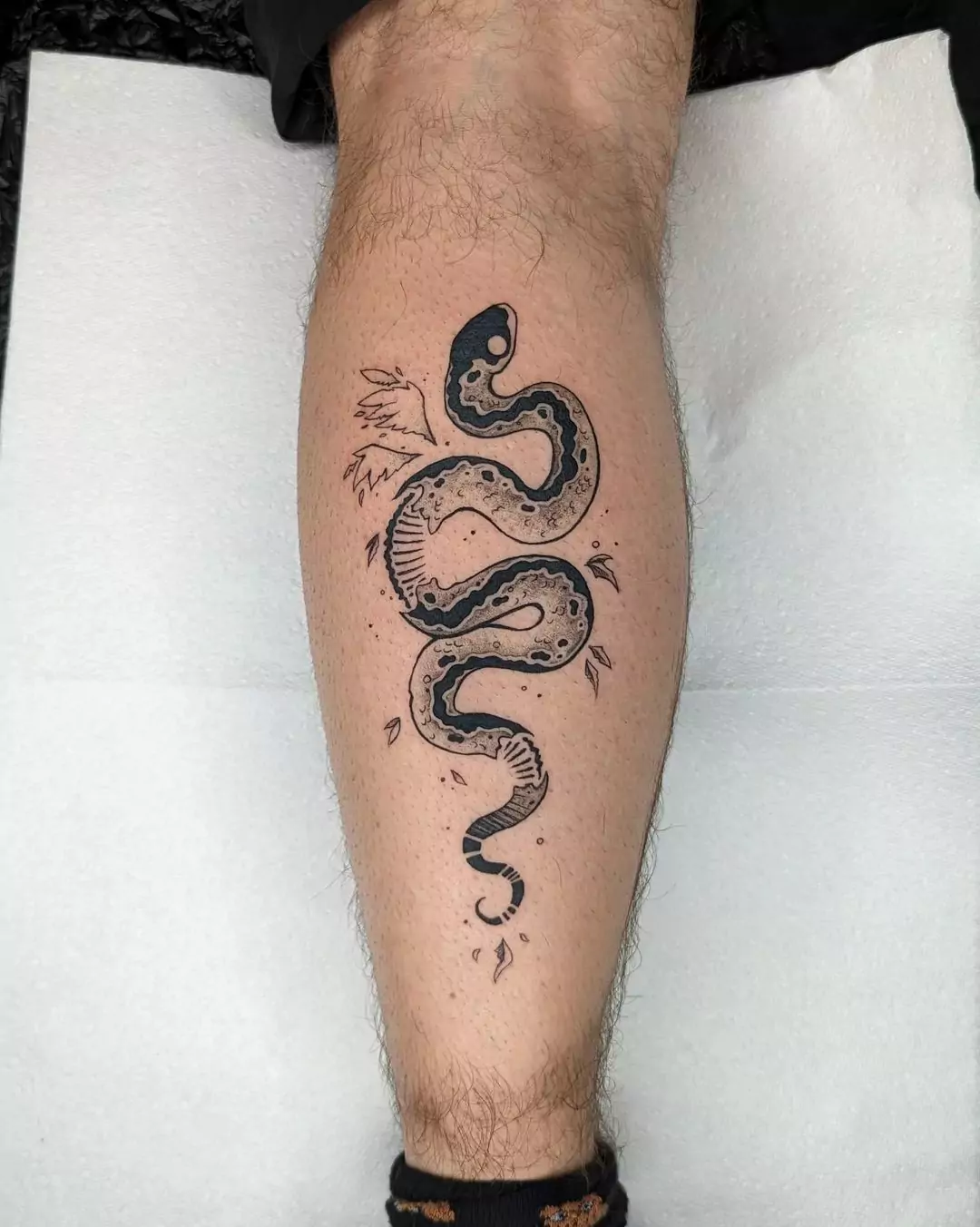 small curly snake calf tattoo