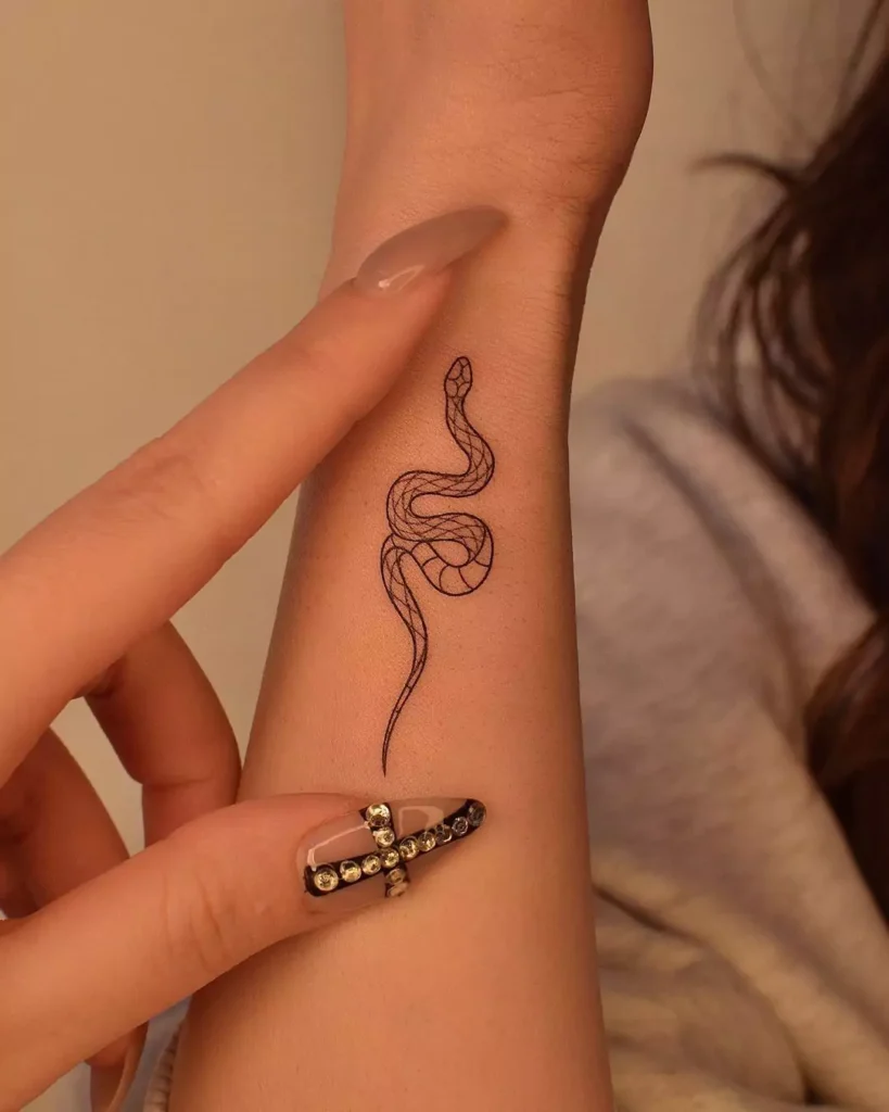 small line art snake hand tattoo