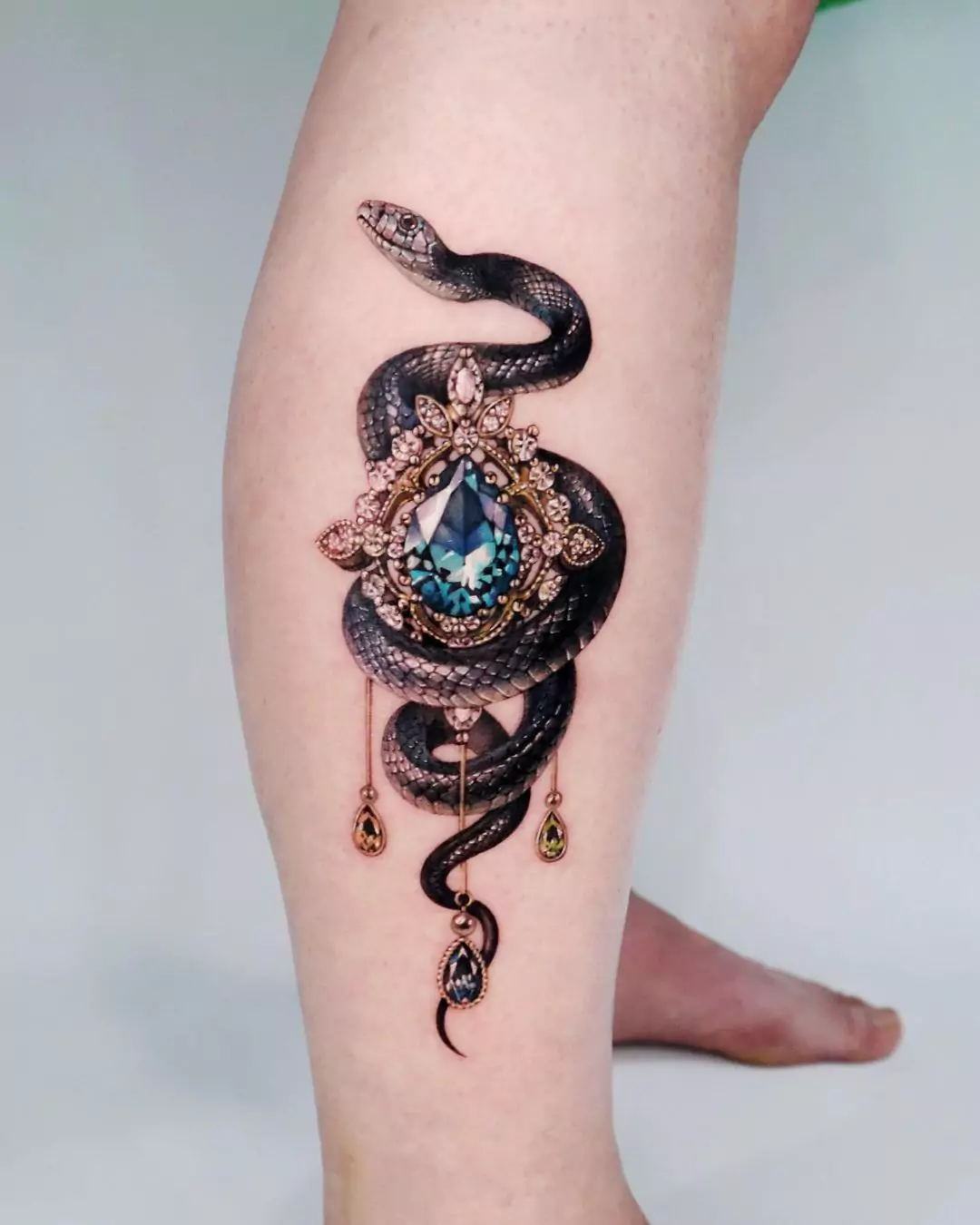 snake and emrald tattoo