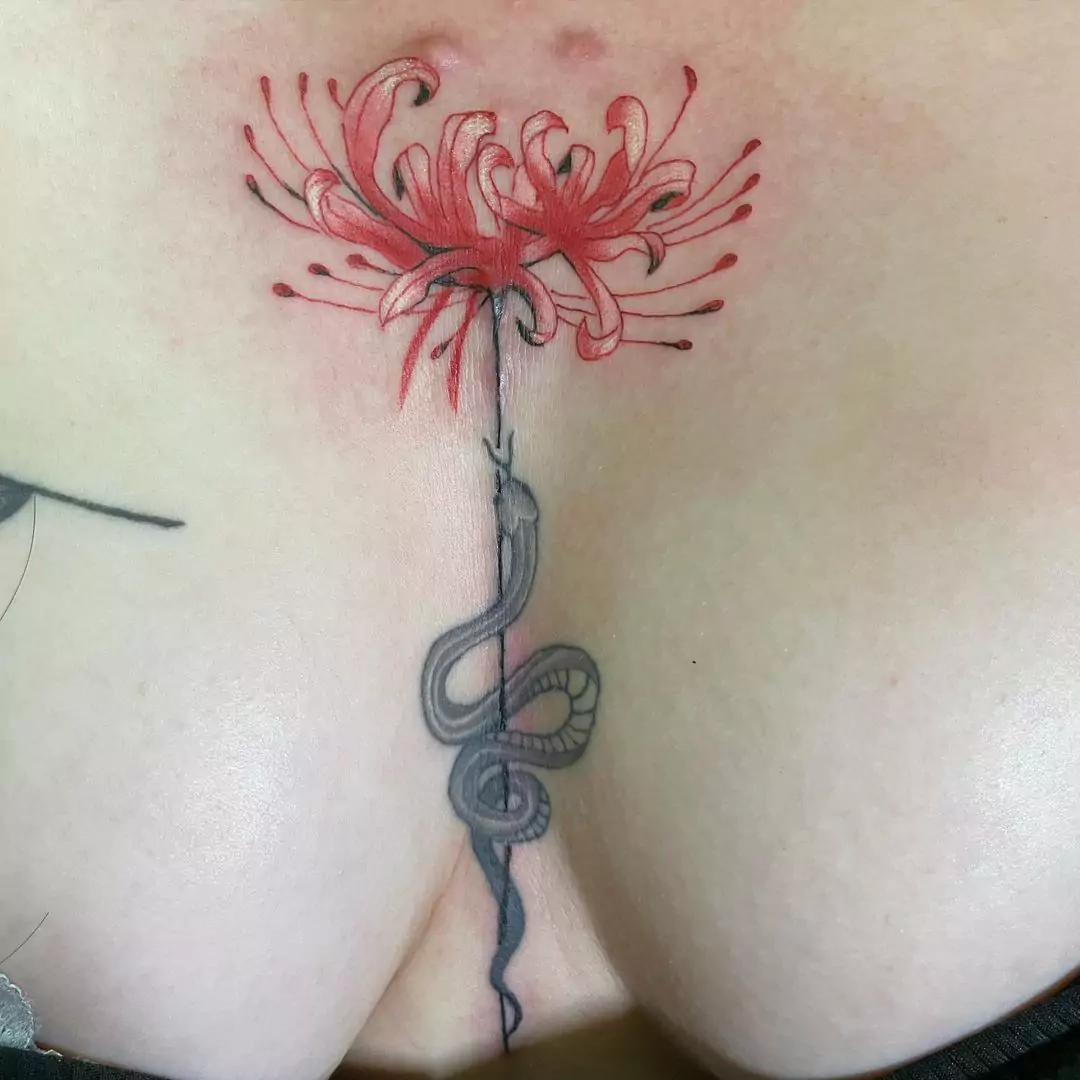 snake and flower tattoo on the sternum