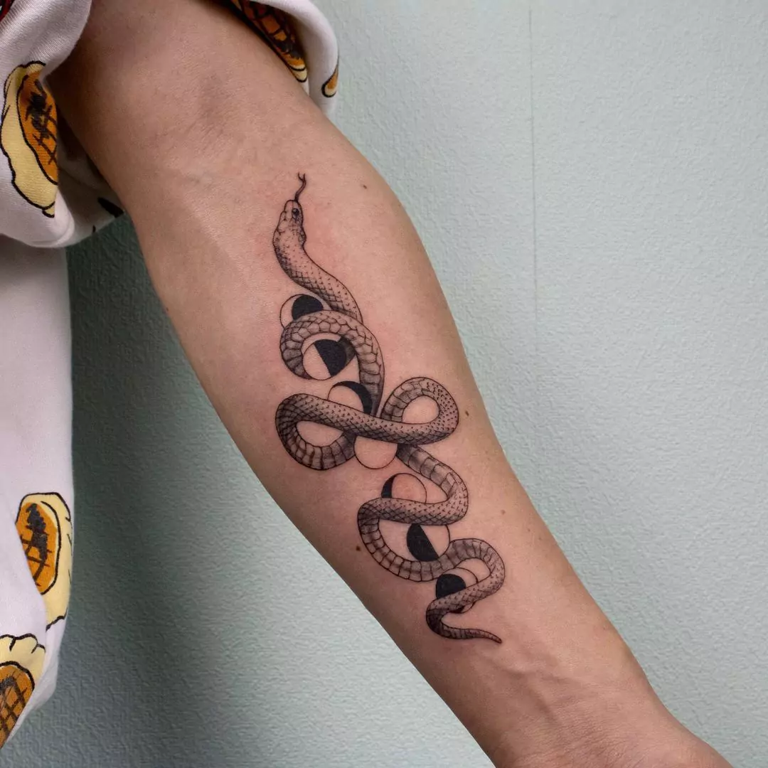 snake and moon phases tattoo