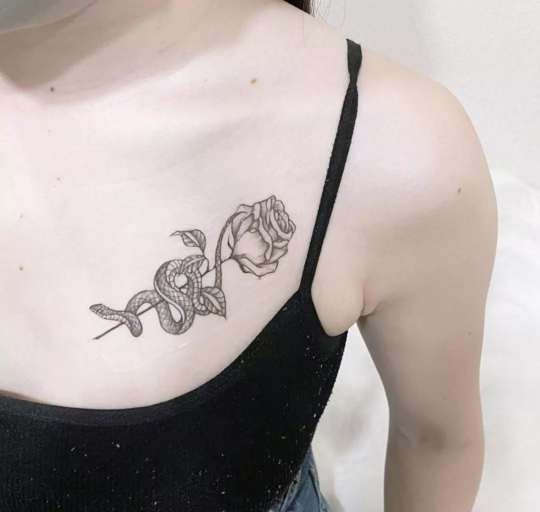 snake and rose chest tattoo