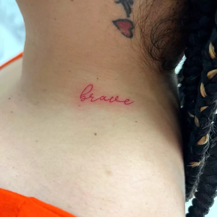 brave word tattoo on the neck