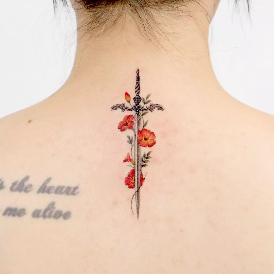 flower and dagger tattoo on nape