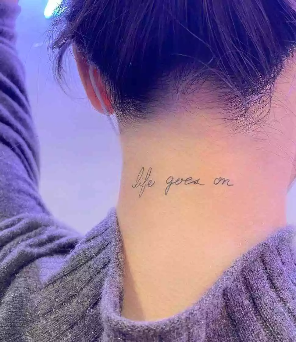 life goes on word tattoo on the nape