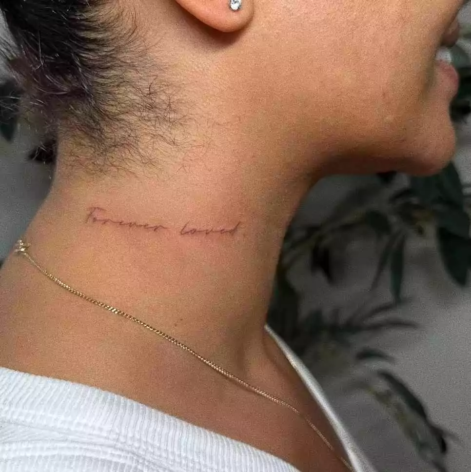 nice word tattoo on neck