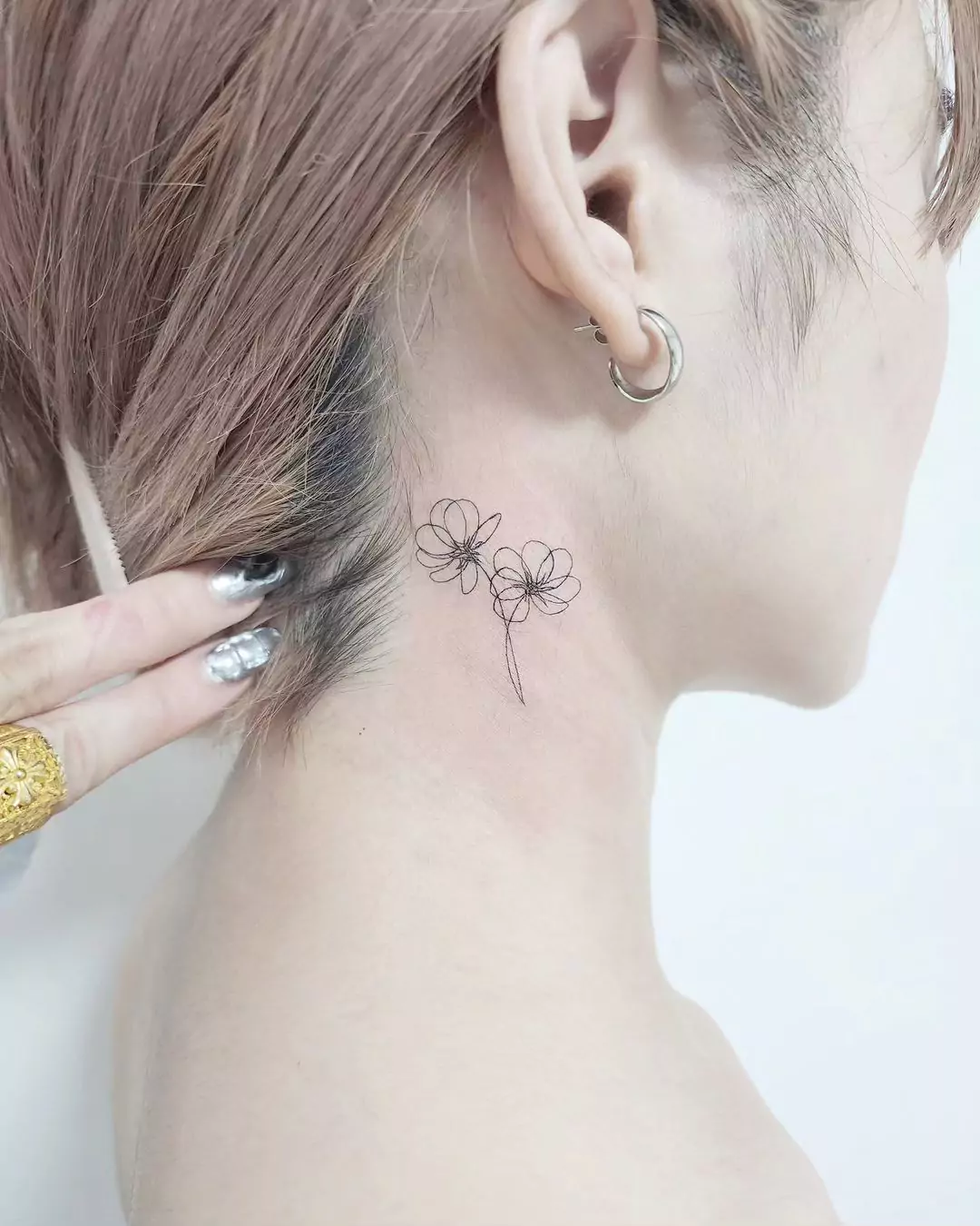 outline style flower tattoo on the neck