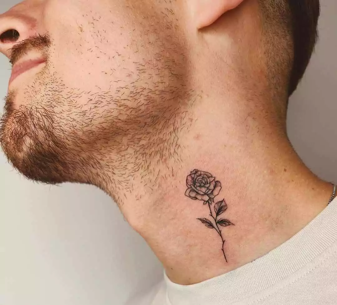 small rose tattoo on neck