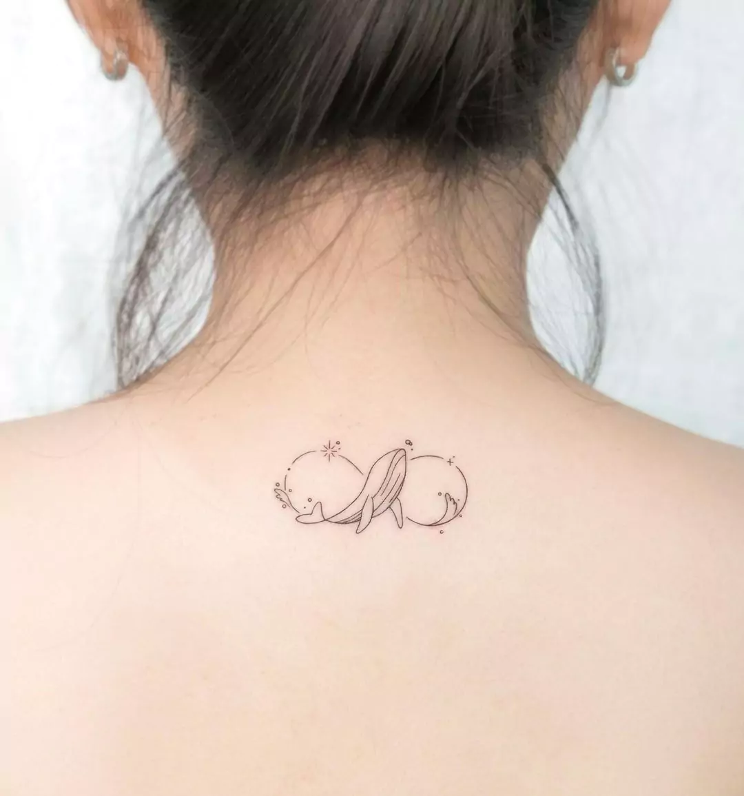 whale tattoo on the neck