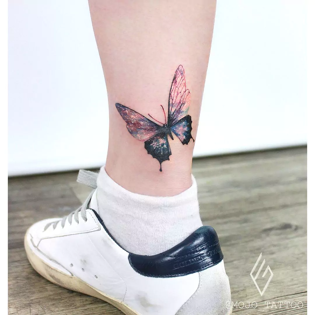 abstract style butterfly tattoo on leg