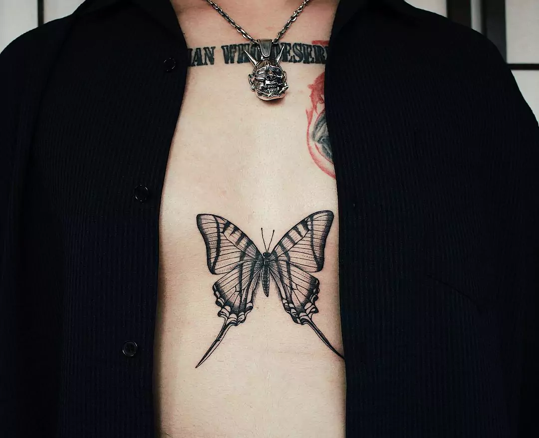 big butterfly tattoo on sternum