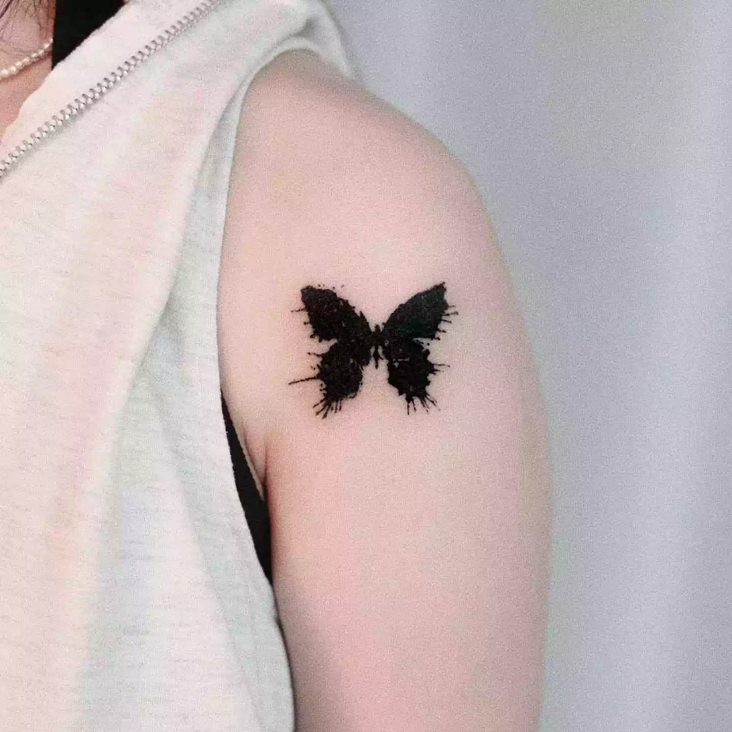 black butterfly hand tattoo