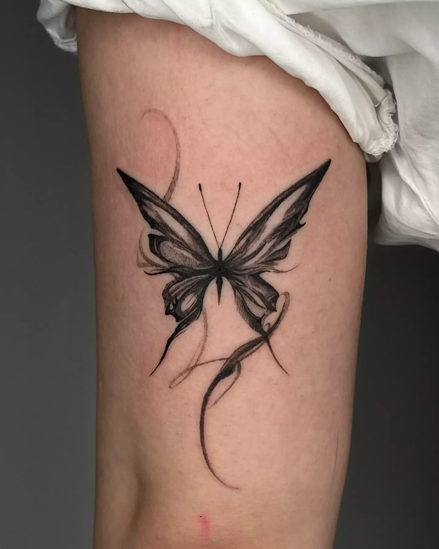 black butterfly tattoo on hand