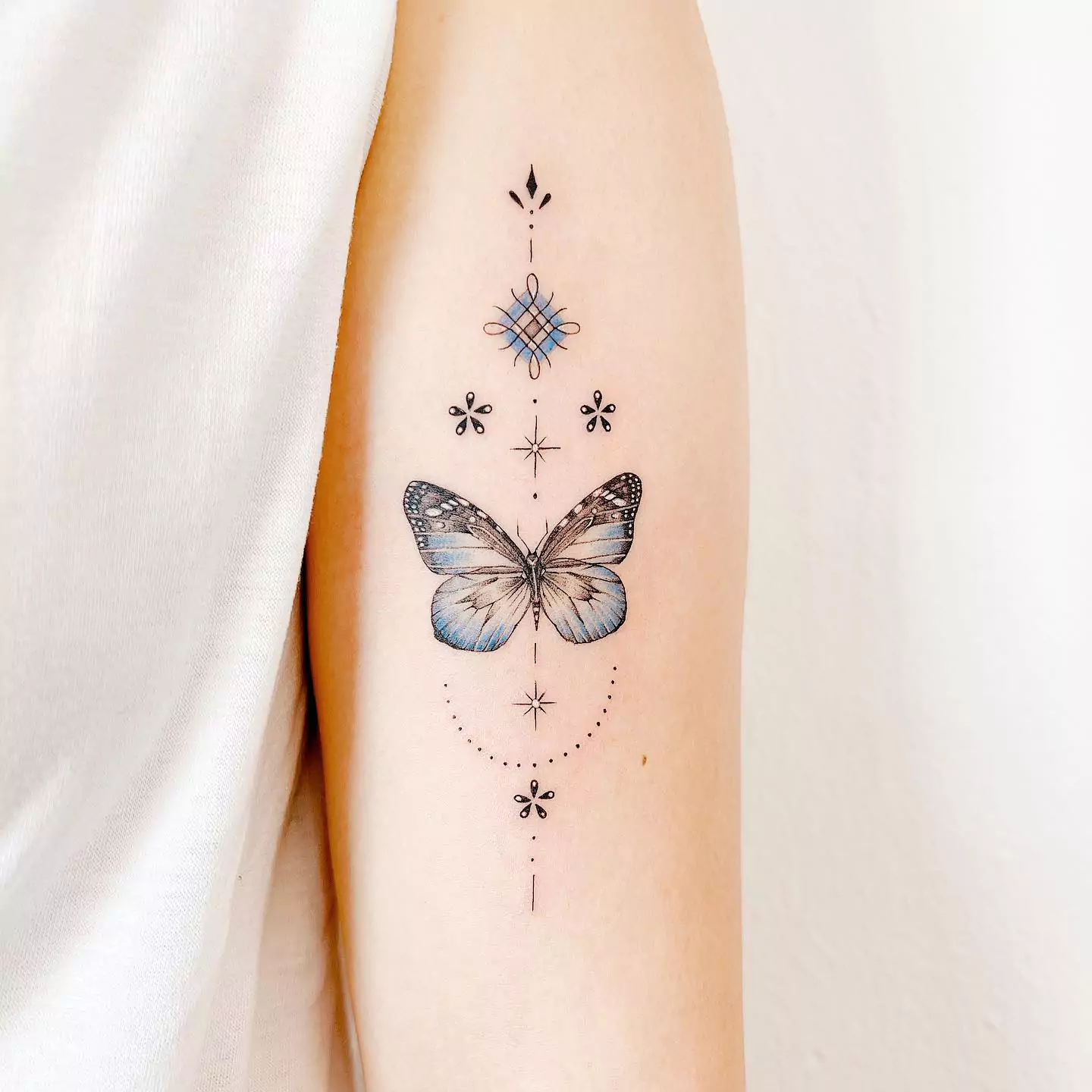 blue color butterfly tattoo